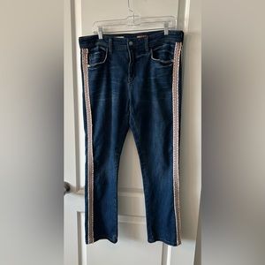 Anthropologie distressed jeans with trim on the sides.